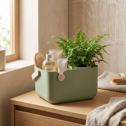 panier de rangement salle de bain rectangle silicone vert sur comptoir avec plante